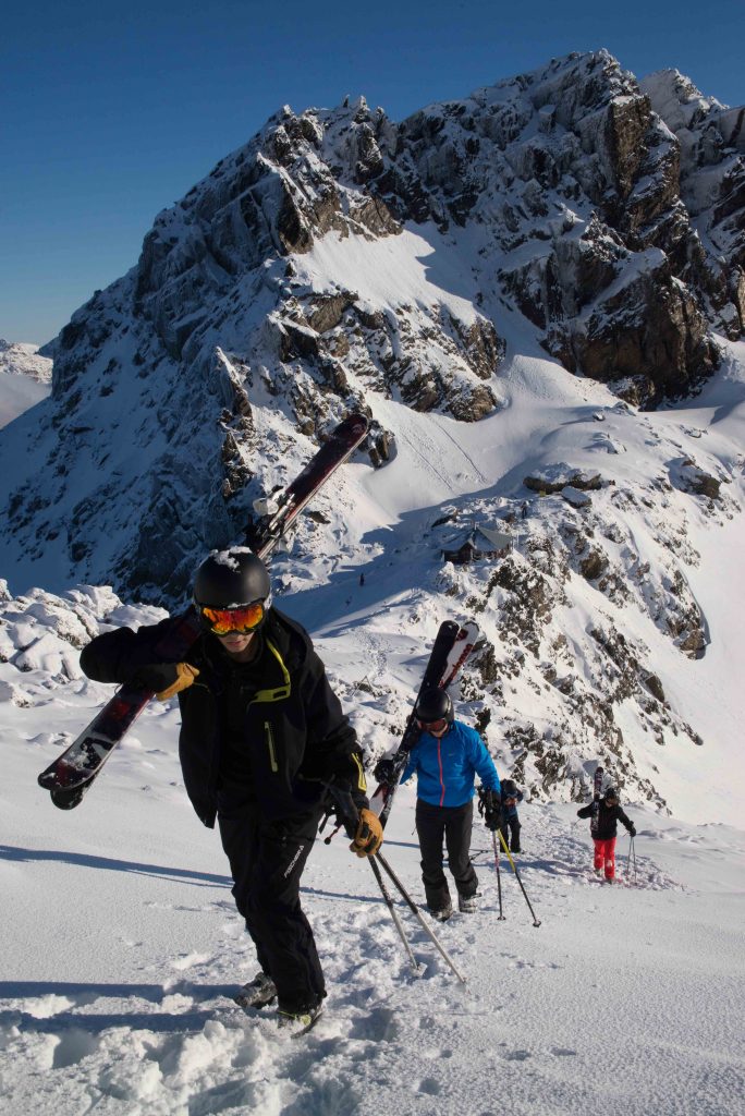 Students taking advantage of Cerro Castor's open bounds policy. Students hike the ridge line above the lifts in search of fresh powder.